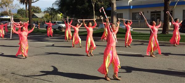 Ayala High Pageantry using large candy canes as props as they march in parade.